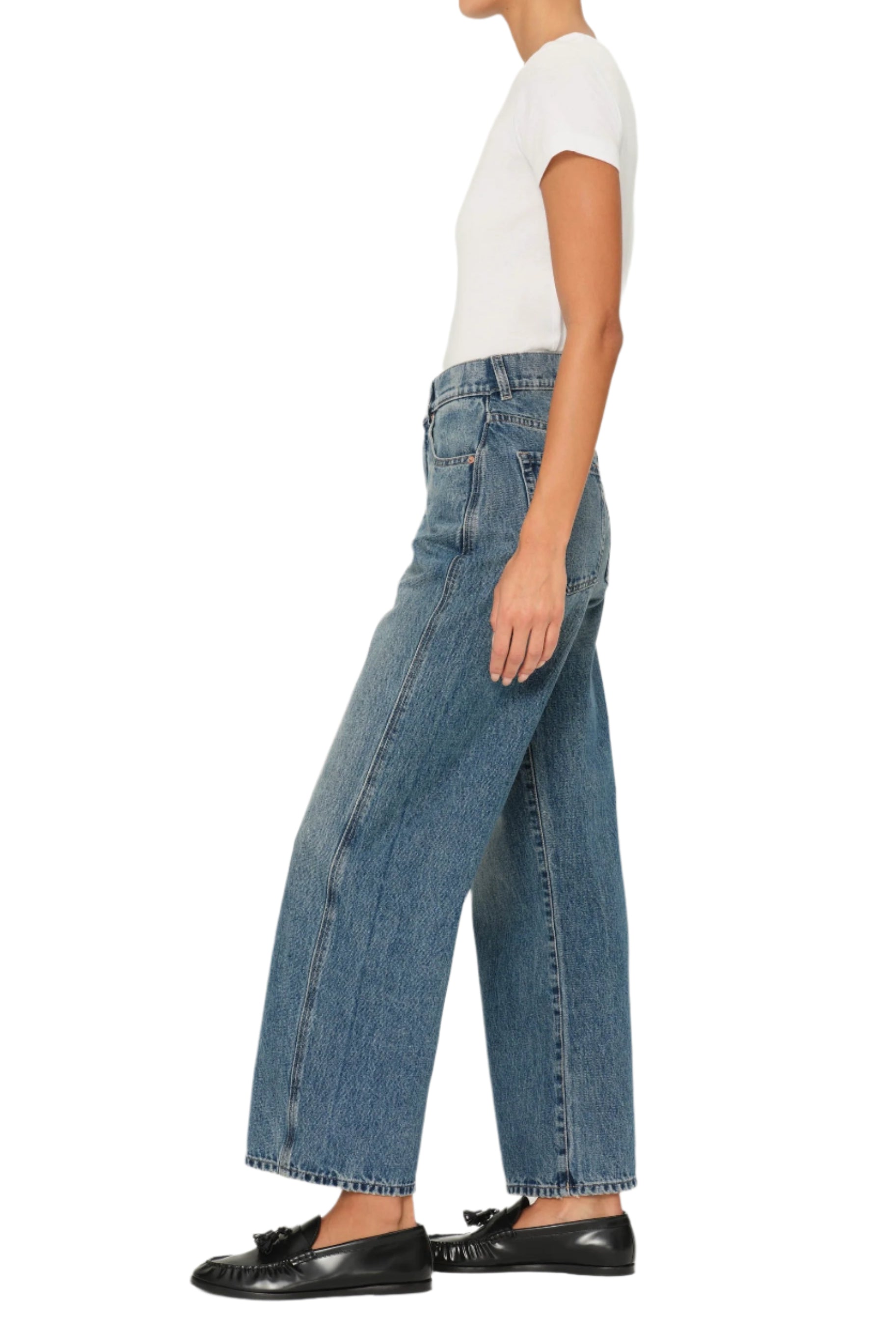 Person wearing blue jeans and black loafers on a white backgroundKARMINE
sassanova