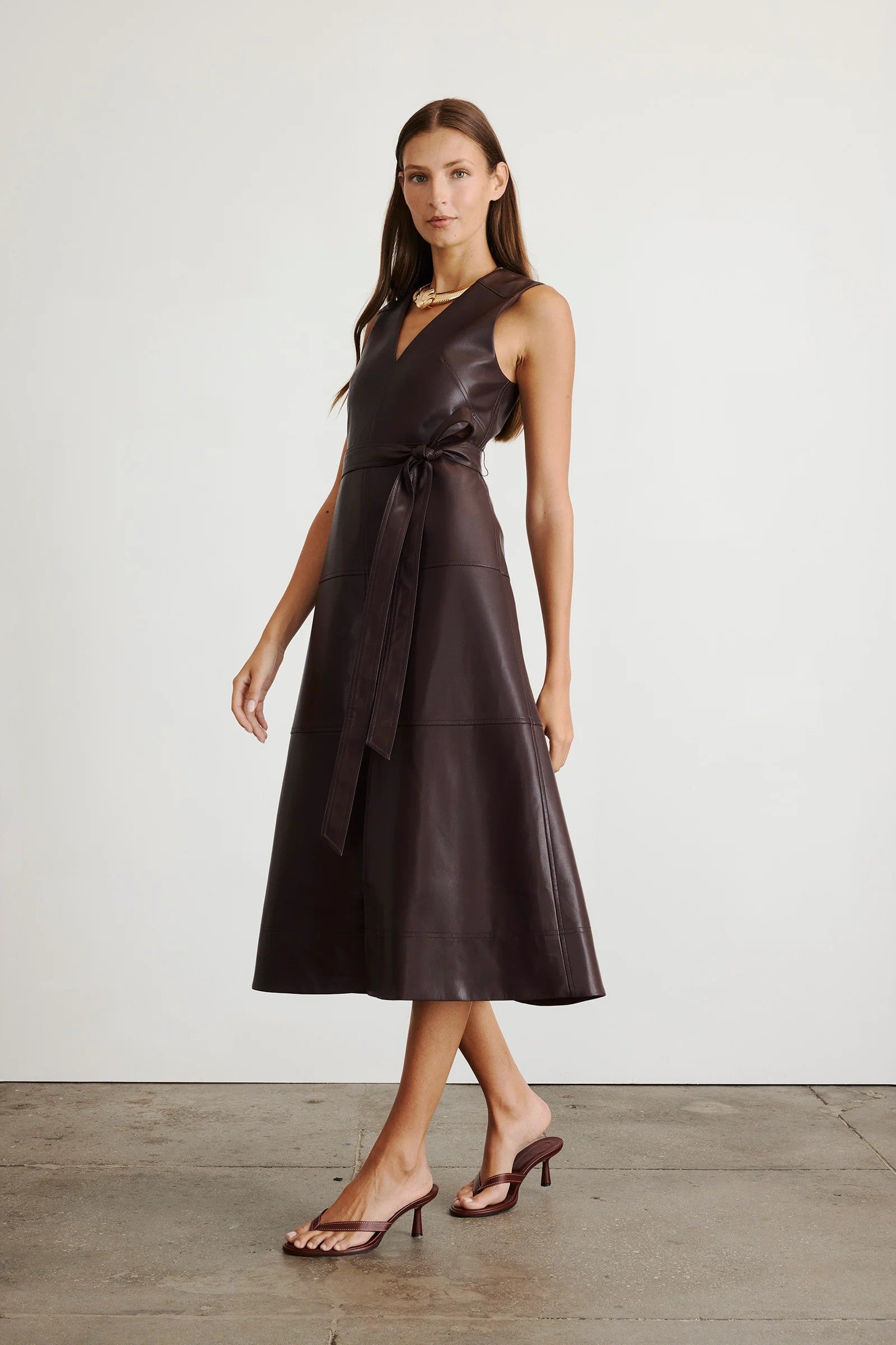 Vegan leather Reina dress in a solid oxblood color with a-line skirt and tie waist-sassanova
