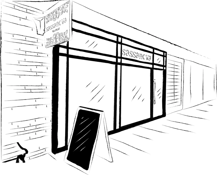 Black and white line art illustration of a storefront with the name 'sassancva' visible on the awning and window, plus an A-frame sidewalk sign in front.