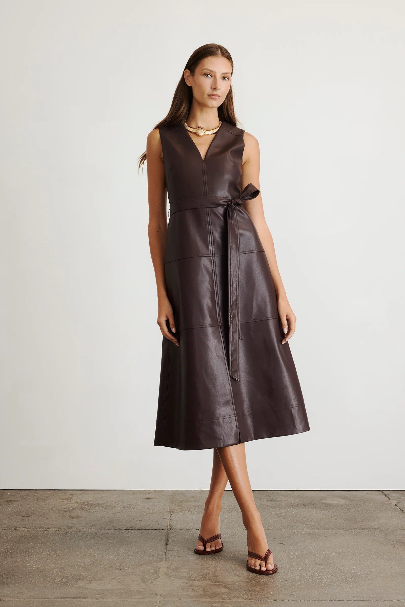 Vegan leather Reina dress in a solid oxblood color with a-line skirt and tie waist-sassanova
